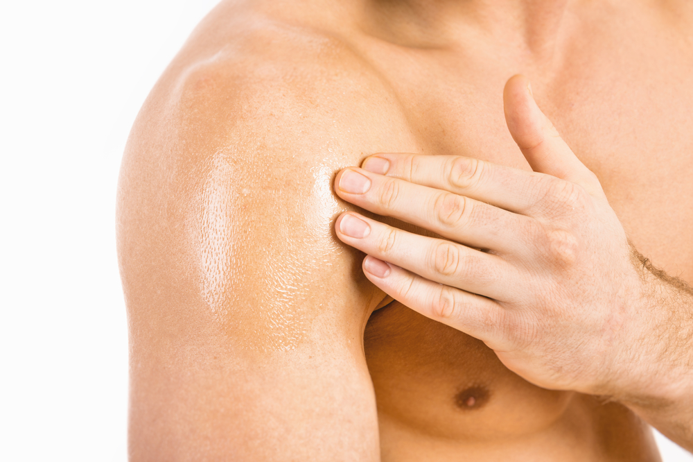 Testosterone,replacement,therapy,(trt), ,muscular,man,applying,testosterone,gel